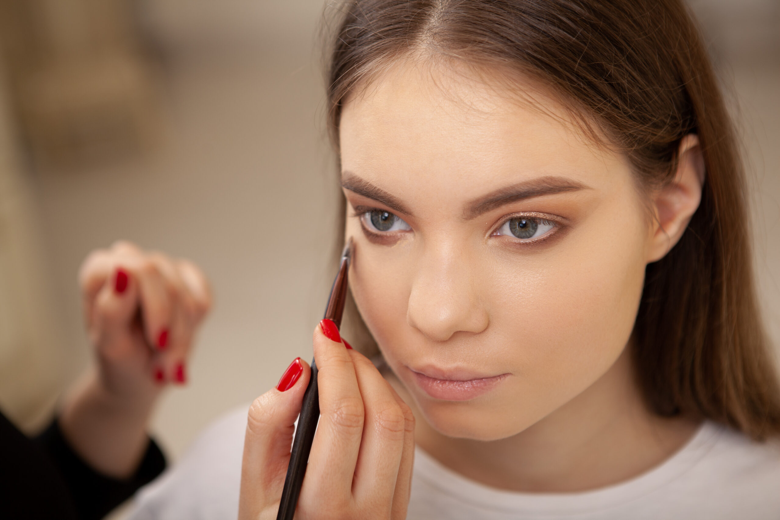 Cropped top view shot of a gorgeous young woman getting professional makeup done at beauty salon